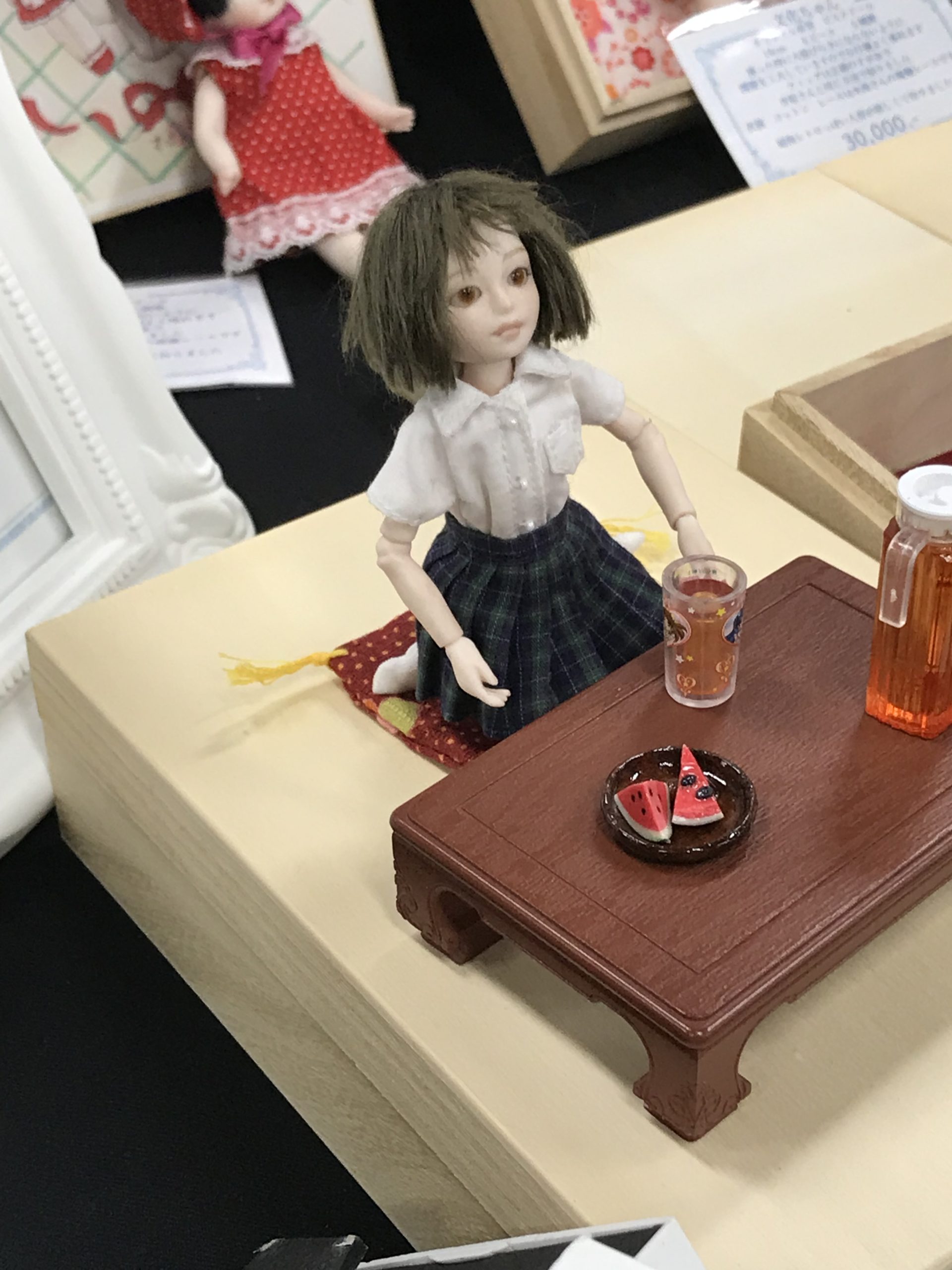 座卓の前に座る人形
